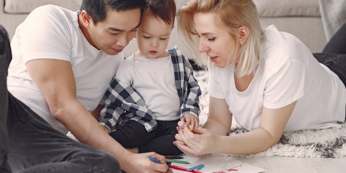 Loving family creating art together, fostering play and connection indoors.